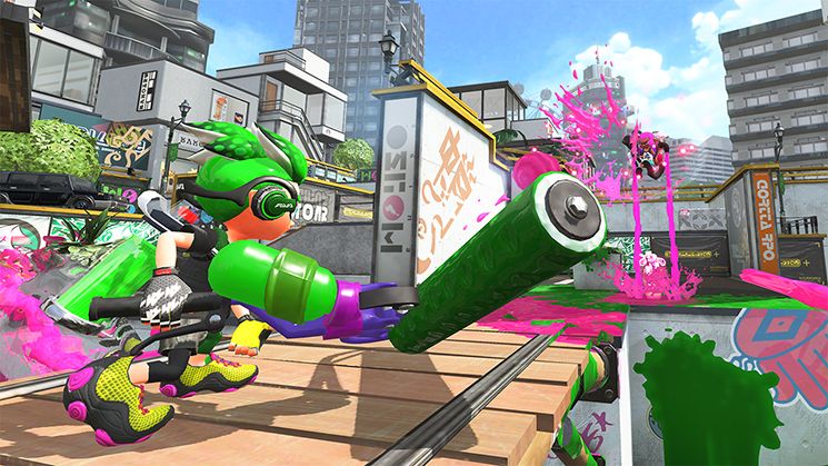 This Splatoon 2 screenshot shows a player character with green hair and a green paintroller turned away. In the distance, a character flies through the air, spilling two streams of pink paint to the ground.